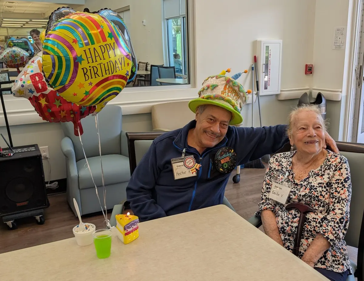 A staff member and an older adult celebrating a birthday at the Adult Day Center